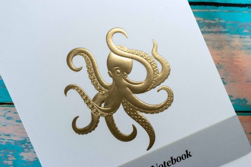 Gold foil embossed octopus notebook on Natural stock.